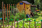 Garden shed with seating area in a kitchen garden in June, Provence, France