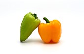 Two sweet peppers of yellow and green color on a light background. Natural product. Natural color. Close-up. [dump] =>
