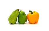 Three sweet peppers of yellow and green color on a light background. Natural product. Natural color. Close-up.