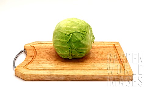 Head_of_cabbage_on_a_wooden_cutting_board_on_a_light_background_Natural_product_Natural_color_Closeu