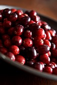 Cranberry, Vaccinium oxycoccos, Mass of red coloured berries in bowl.