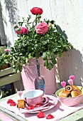 TABLE DECORATED WITH HEARTS AND POTTED RANUNCULUS
