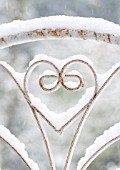 SNOW ON IRON GATE WITH HEART SHAPED DECORATION