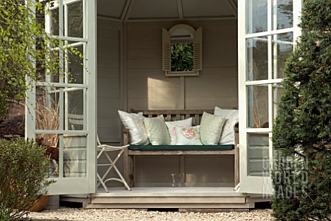 INTERIOR_OF_GARDEN_SUMMERHOUSE_WITH_SEAT_AND_CUSHIONS