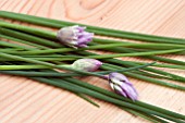 CHIVES ON A WOODEN BOARD
