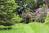 RUSTIC SUMMERHOUSE IN THE RIVERSIDE GARDEN AT PITMUIES HOUSE. FORFARSHIRE, SCOTLAND