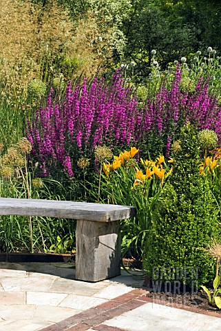 CURVED_WOODEN_BENCH_IN_THE_HERBACEOUS_BORDER_AT_RHS_HARLOW_CARR