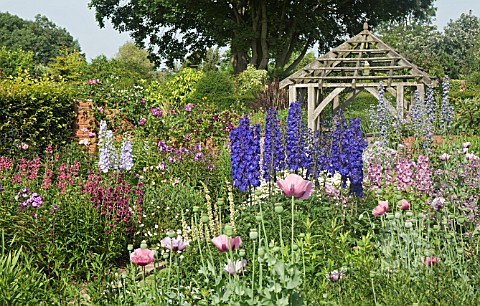 DEEP_BORDERS_OF_MIXED_COLOURS_AND_OAK_PERGOLA_AT_WOLLERTON_OLD_HALL
