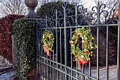Holly wreaths on entrance gates