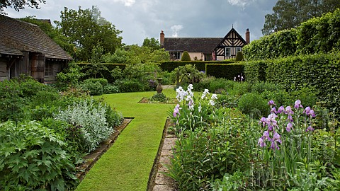 Twin_borders_bursting_with_herbaceous_perennials