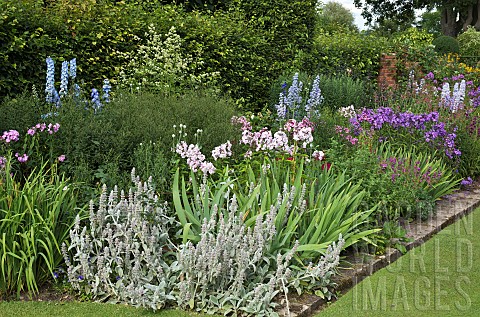 Wide_border_edged_with_bricks_to_lawn_many_varieties_of_herbaceous_perennials