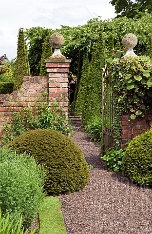 Gravel_path_through_wrought_iron_gate_leading_to_outstanding_country_garden