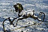 SNOW ON ROCKING HORSE IN GARDEN