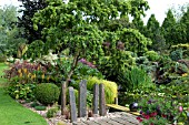 JOHNS GARDEN AT ASHWOOD NURSERIES   POOL WITH SURROUNDING SHRUBS CONIFERS TREE AND STAGING